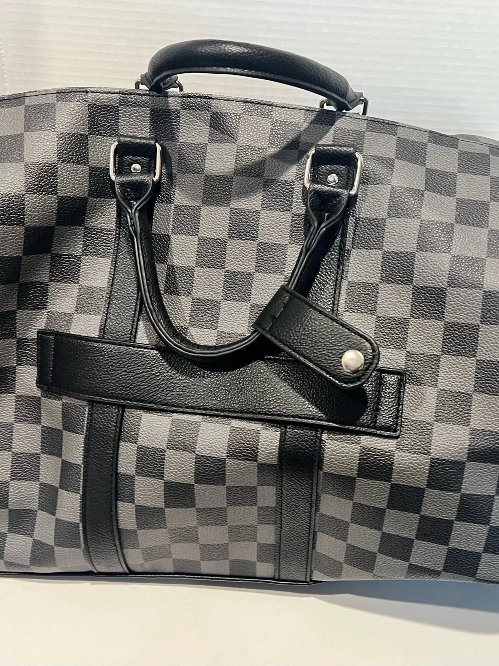 Ed Hardy duffel bag features a black and grey checkered pattern
